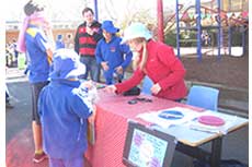 Senior students making a sale at their stall for Mini Market Day